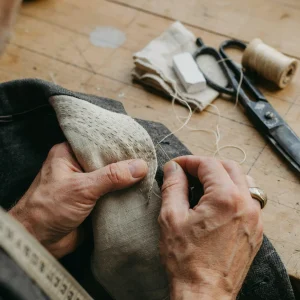 best bangkok tailors hand-stitching canvas into a suit jacket