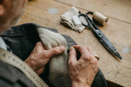 best bangkok tailors hand-stitching canvas into a suit jacket