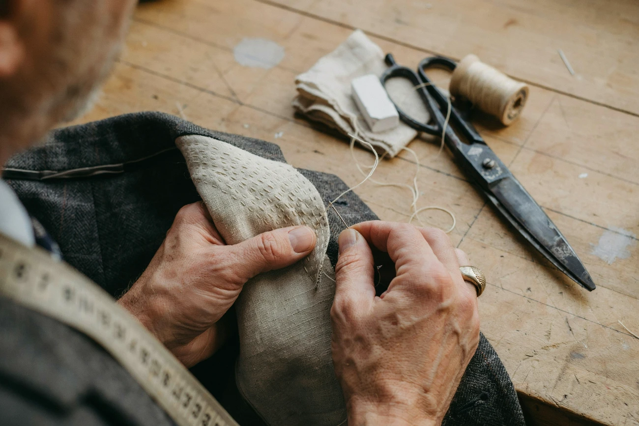 best bangkok tailors hand-stitching canvas into a suit jacket